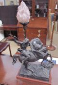 A spelter lamp in the form of a horse woman on horseback being attacked by a lion