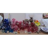 Assorted cranberry glass together with blue glass vases, medicine bottles, converted oil lamp,