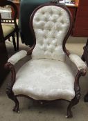 A Victorian walnut library chair, with a carved floral cresting,