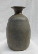 A studio pottery vase, with a mottled blue green ground, impressed with initials and "TUGWMMWD",