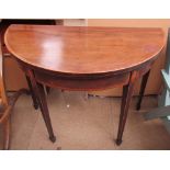 A 19th century mahogany card table of D shape with shell inlaid square tapering legs and spade