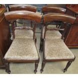 A set of four Regency mahogany dining chairs with leaf carved bar backs and drop in seats on