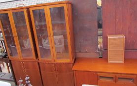 A pair of modern display cabinets with cupboard base,