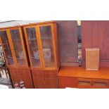 A pair of modern display cabinets with cupboard base,