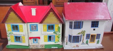A doll's house with a red painted roof and yellow shutters together with another doll's house