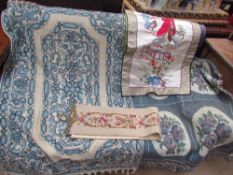 A crewel work rug with a blue ground together with a blanket and silkworm panels