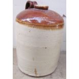 A large stoneware storage jar stamped “F.W. Berk & Co.