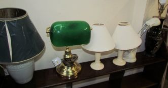A green glass desk lamp together with a collection of table lamps