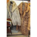 A three quarter length fur coat and another coat