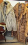 A three quarter length fur coat and another coat