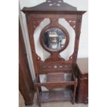 A 20th century walnut hallstand with a circular mirror, central hinged compartment,