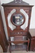 A 20th century walnut hallstand with a circular mirror, central hinged compartment,