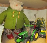A Paddington Bear teddy together with toy tractors etc