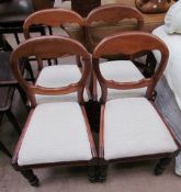 A set of four Victorian balloon back dining chairs with drop in seats on turned legs