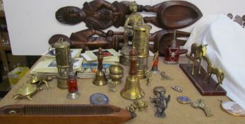 A brass miners lamp together with a brass miner, brass bells, loom shuttle, postcards,