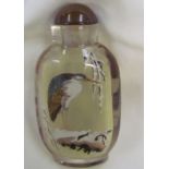 A glass snuff bottle decorated with an egret to one side and another bird to the other
