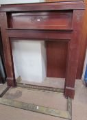 A 20th century mahogany fire surround with scrolling decoration together with two brass fire