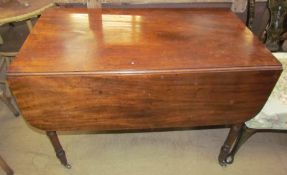 A Victorian mahogany Pembroke table with a rectangular top and drop flaps on turned legs and