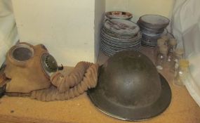 A WWII tin helmet and gas mask,