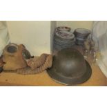 A WWII tin helmet and gas mask,