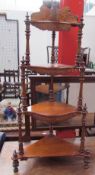 A Victorian walnut four tier whatnot with marquetry decoration and spindle uprights