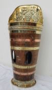 A coopered and brass umbrella stand, the raised back embossed with grapes and leaves,