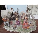 A large Capodimonte figure group of a gypsy encampment,