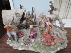 A large Capodimonte figure group of a gypsy encampment,