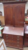 A 19th century mahogany bureau bookcase with a cupboard top,