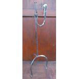 A wrought iron rush light and candle holder,