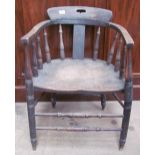 A smoker's bow elbow chair with spindle back and solid seat