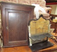 An 18th century oak hanging corner cupboard together with an ebonised wall mirror with floral