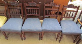 A matched set of four Edwardian salon chairs with spindle backs and pad seats on turned legs