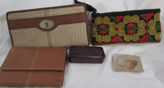 A Fossil clutch bag together with an Osprey purse, another purse,