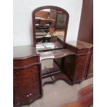 A Victorian mahogany dressing table with a central mirror with arched top,