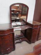 A Victorian mahogany dressing table with a central mirror with arched top,