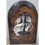A carved panel depicting a masted ship