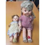 A pedigree doll together with another