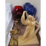 A Booksy plaster figure of dancing figures together with a pair of brass candlesticks,