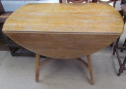A mid-20th century light ash drop leaf dining table