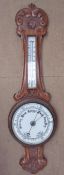 An oak framed aneroid barometer with ceramic dials