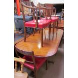 A reproduction mahogany extending dining table together with a set of six reproduction mahogany