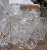 A collection of crystal drinking glasses, dishes,