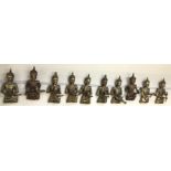 A set of ten carved and gilt decorated Thai figures all playing musical instruments