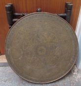 A brass topped Anglo Indian table with a folding base