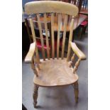 A kitchen slat back elbow chair with a solid seat on turned legs