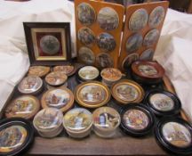 A large collection of pot lids, some mounted, some framed,