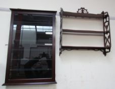 A 20th century wall mounted display cabinet together with a set of open hanging shelves