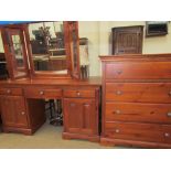 A modern dressing chest together with a dressing table and a large triptych mirror