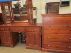 A modern dressing chest together with a dressing table and a large triptych mirror
